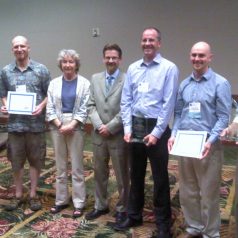 Dr. Rodney Cluck and Dr. Joan Cleveland posing with winners of the FY13 Award for Excellence in Partnering. Left to Right: Dr. Joseph Needoba (CMOP Oregon Health and Sciences U.), Dr. Rob Campbell (Prince William Sound Science Center), Dr. Joan Cleveland (ONR), Dr. Rodney Cluck (BOEM), Dr. Andrew Barnard (Principal Investigator, WET Laboratories), Dr. Corey Koch (WET Labs), and Mr. Casey Moore (WET Labs)